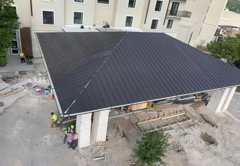 Metal roofing installation team working on a commercial building in Fredonia